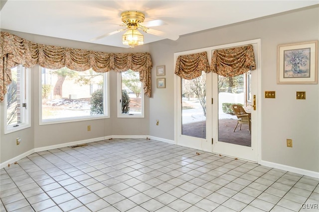 unfurnished dining area with light tile patterned floors and ceiling fan