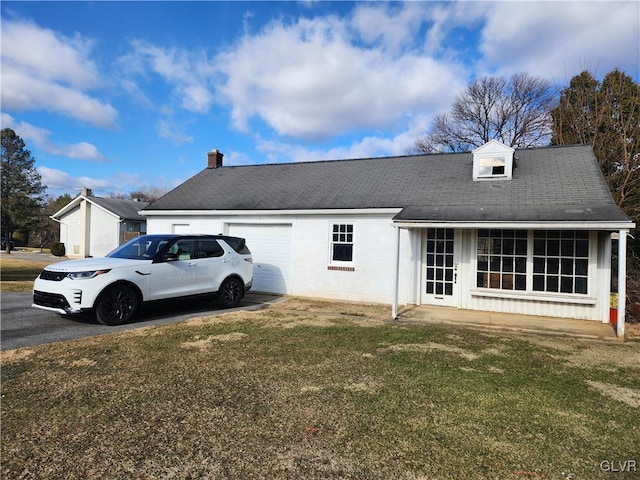 exterior space featuring a garage and a front yard