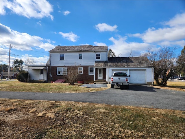 view of property with a garage and a front yard