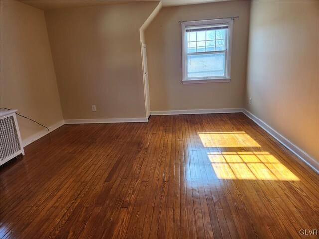 additional living space with dark hardwood / wood-style floors