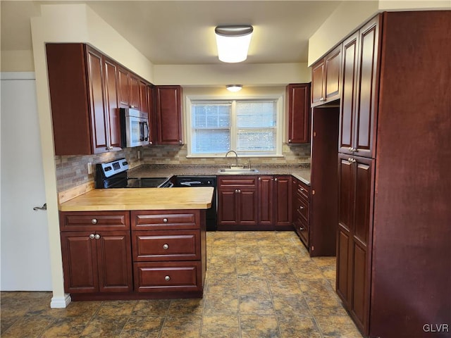 kitchen with tasteful backsplash, appliances with stainless steel finishes, and sink