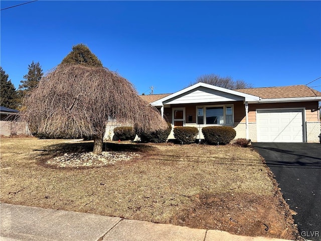 view of front of property with a garage and a front lawn