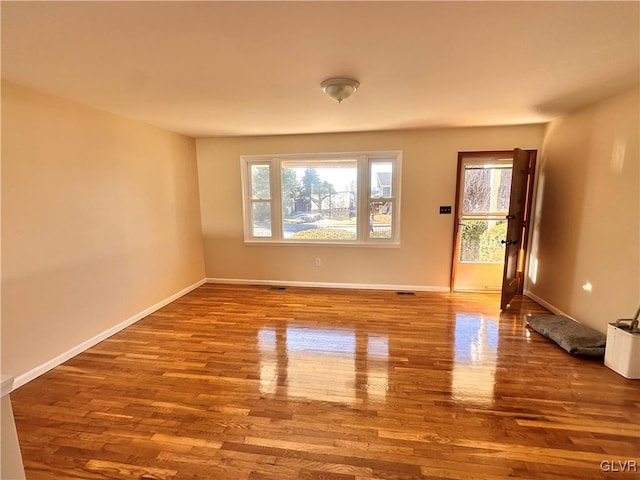 empty room with light hardwood / wood-style flooring