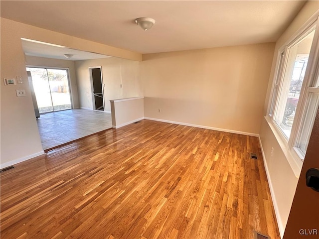 unfurnished room with light wood-type flooring