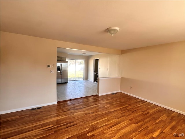 unfurnished room with hardwood / wood-style floors