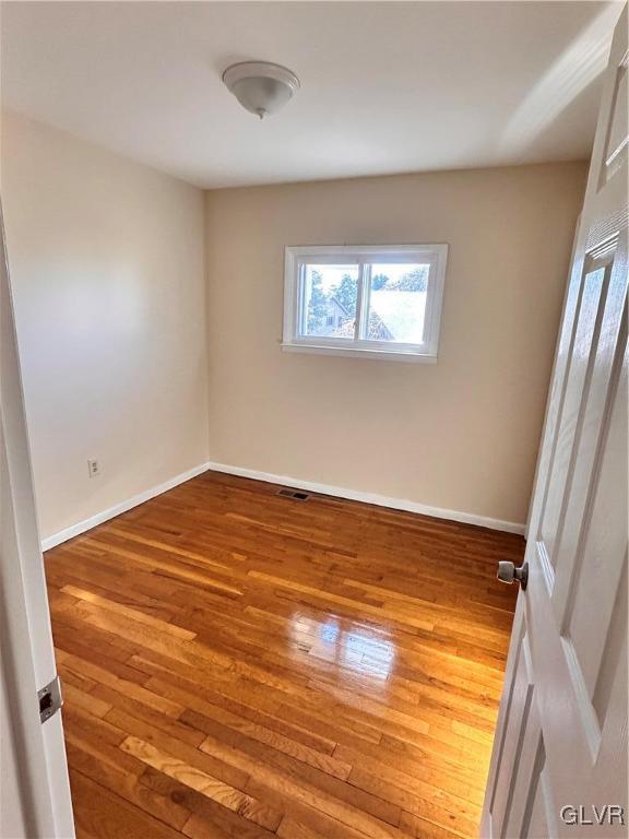 empty room featuring hardwood / wood-style flooring