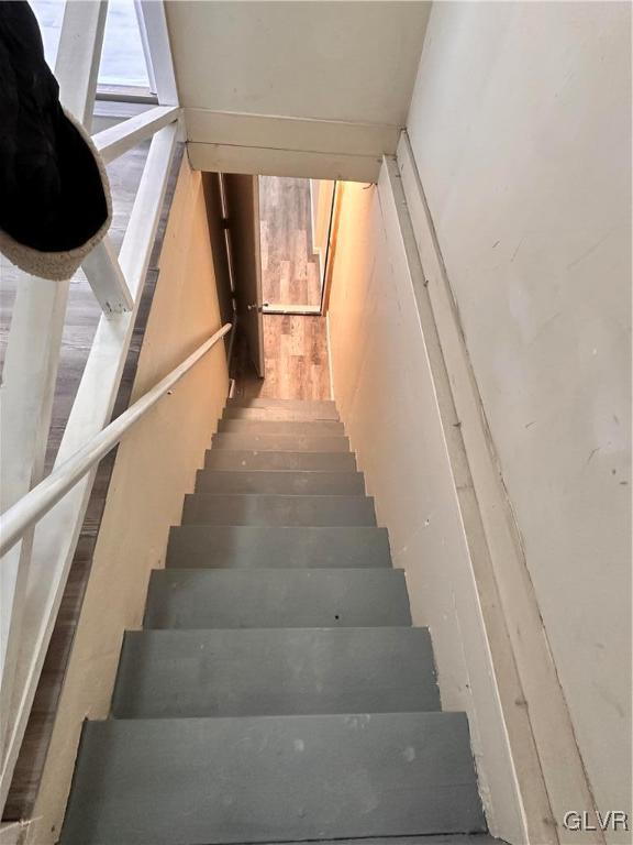 staircase with hardwood / wood-style flooring