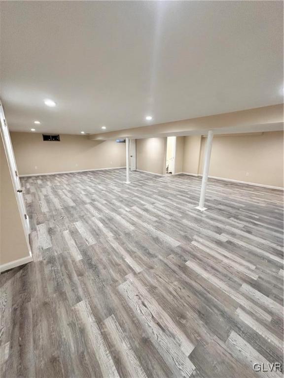 basement with hardwood / wood-style floors