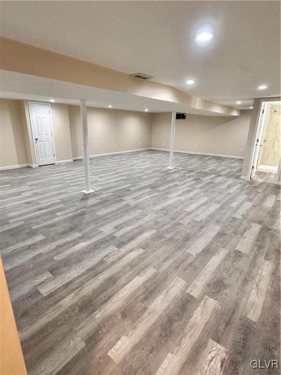 basement with hardwood / wood-style floors