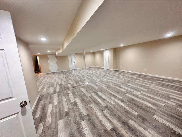 basement with hardwood / wood-style flooring