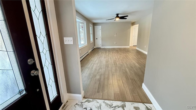 entrance foyer with baseboard heating, ceiling fan, and light hardwood / wood-style flooring