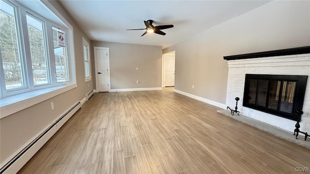 unfurnished living room with ceiling fan, a brick fireplace, light wood-type flooring, and baseboard heating