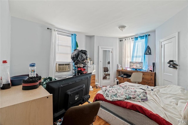 bedroom featuring cooling unit and light hardwood / wood-style floors