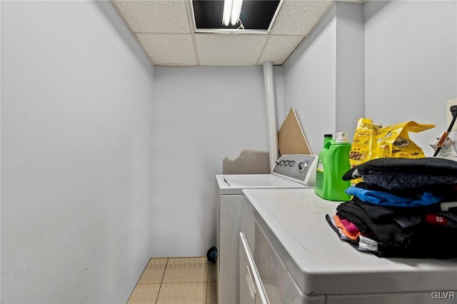 washroom featuring washing machine and clothes dryer and light tile patterned flooring