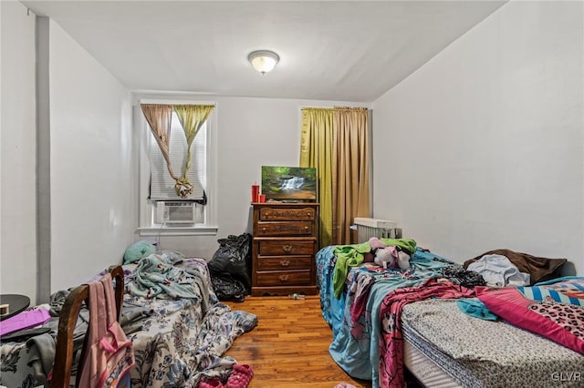 bedroom featuring hardwood / wood-style flooring and cooling unit