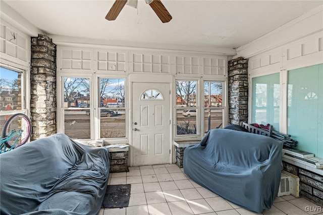 sunroom featuring ceiling fan