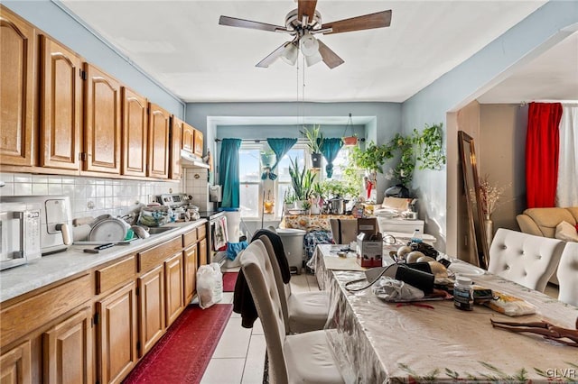 dining area featuring light tile patterned floors and ceiling fan