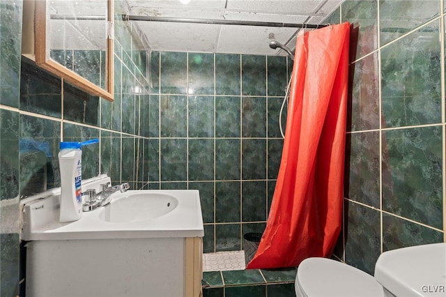 bathroom featuring tile walls, vanity, toilet, and a shower with shower curtain