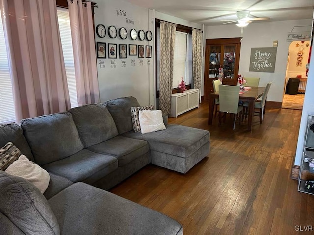 living room with dark wood-type flooring, ceiling fan, and radiator heating unit