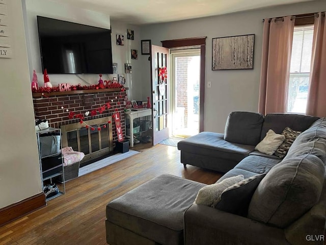 living room with a healthy amount of sunlight, hardwood / wood-style floors, and a fireplace