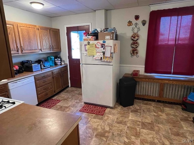 kitchen featuring radiator heating unit, a paneled ceiling, and white appliances