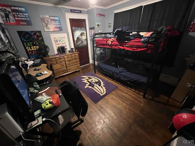 bedroom with ornamental molding and wood-type flooring