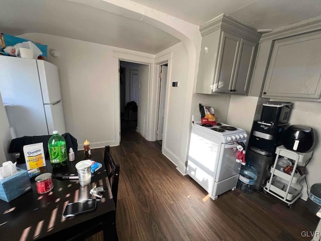 kitchen with white appliances, gray cabinets, and dark wood-type flooring