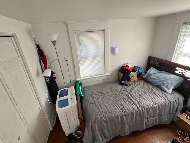 bedroom with dark wood-type flooring