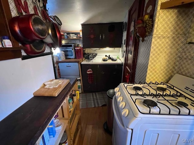 kitchen featuring dark wood-type flooring and white range with gas stovetop