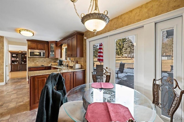 dining space with sink, french doors, and a healthy amount of sunlight