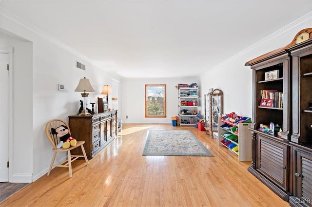 interior space featuring crown molding and light wood-type flooring