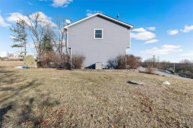 view of side of home with a yard