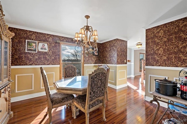 dining space featuring an inviting chandelier, ornamental molding, and wood-type flooring