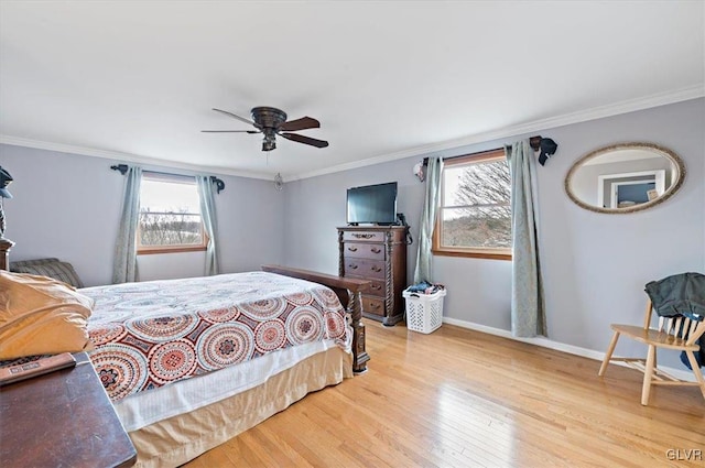 bedroom featuring multiple windows, crown molding, and light wood-type flooring