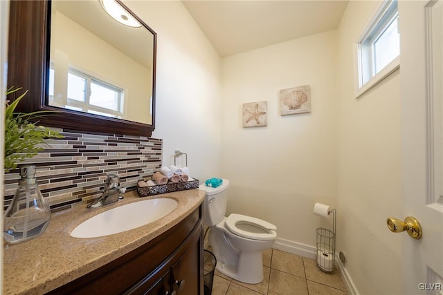 bathroom with vanity, toilet, tile patterned flooring, and backsplash