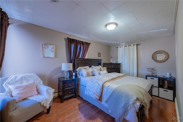 bedroom with hardwood / wood-style flooring