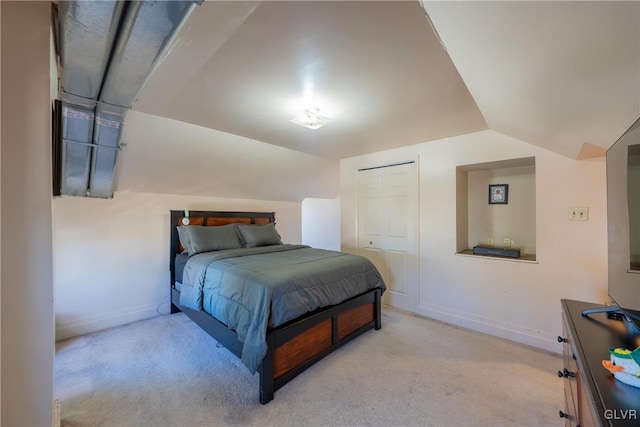 bedroom featuring vaulted ceiling and light colored carpet