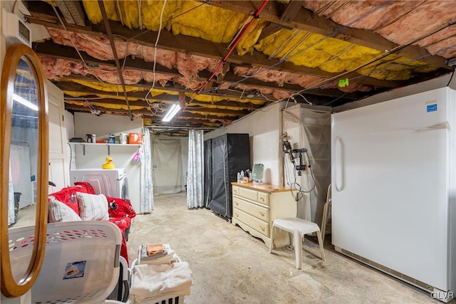 basement with fridge and independent washer and dryer