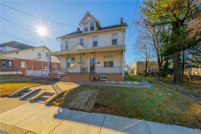 view of front of home with a front lawn and a porch