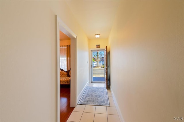 hall with light tile patterned floors