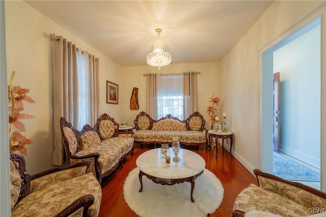 living area featuring hardwood / wood-style flooring and a chandelier