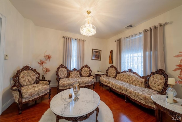 living room with an inviting chandelier and dark hardwood / wood-style floors