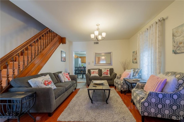 living room featuring hardwood / wood-style floors and a chandelier