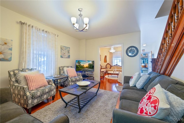 living room with hardwood / wood-style flooring and a chandelier