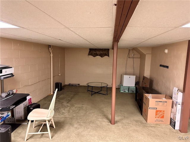 basement with a paneled ceiling