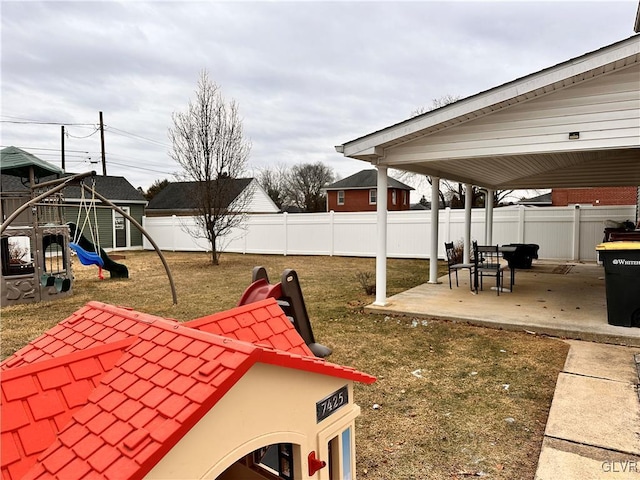 view of yard with a playground and a patio