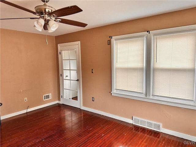 unfurnished room featuring dark wood-type flooring and ceiling fan