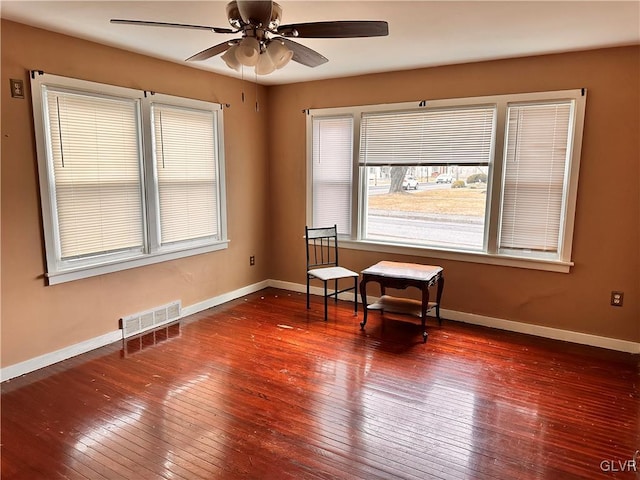 empty room featuring wood-type flooring and ceiling fan