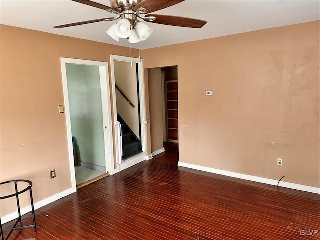 unfurnished room featuring dark hardwood / wood-style flooring and ceiling fan