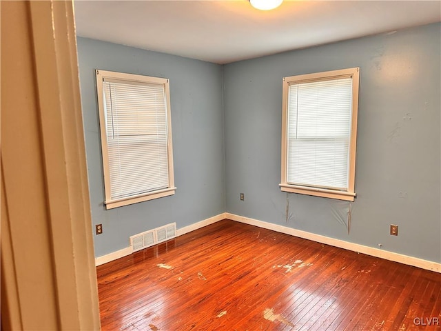 unfurnished room with hardwood / wood-style flooring